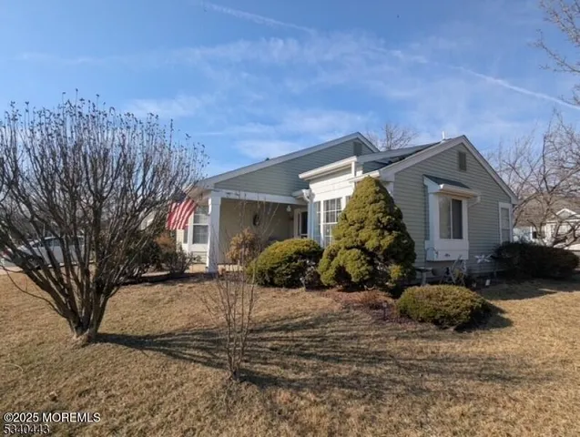 a view of a house with a yard covered in snow