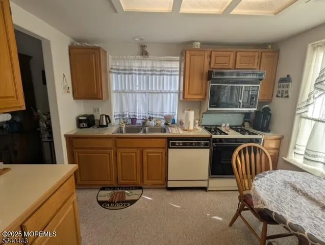 a kitchen with a sink appliances and cabinets