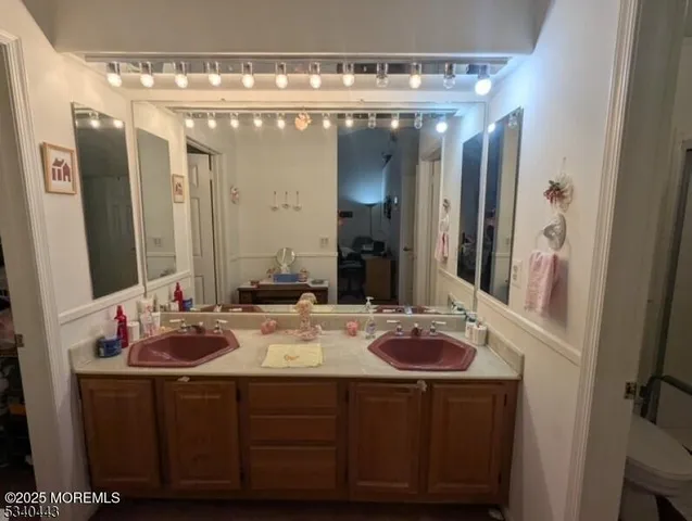 a bathroom with a double vanity sink and a mirror