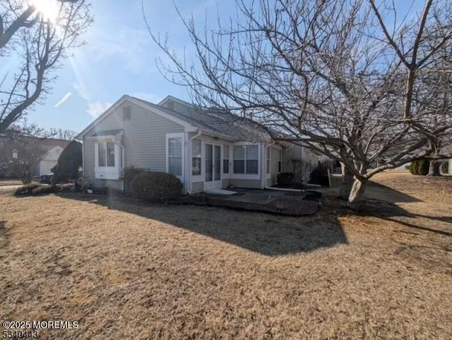 a front view of a house with a yard covered in snow