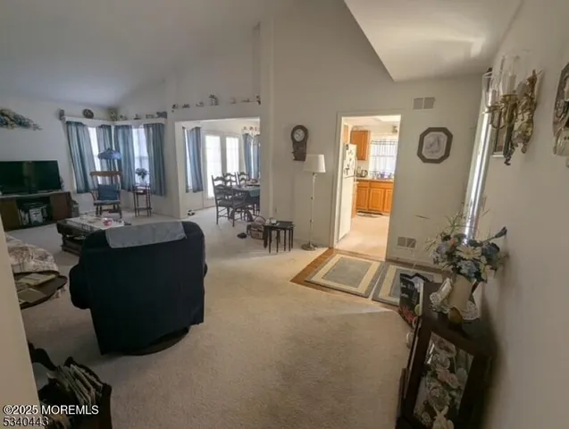 a living room with furniture gym equipment and a large window