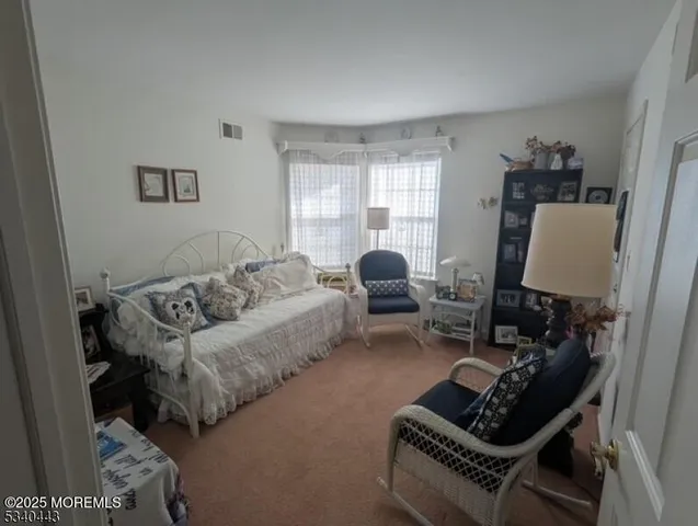 a living room with furniture a couch and a window