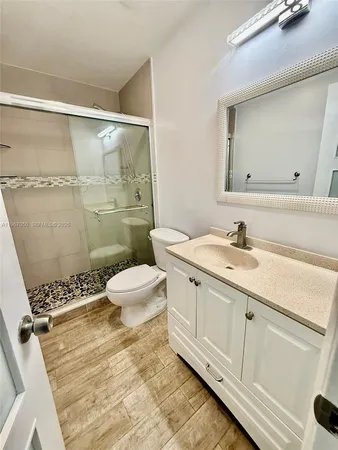 a bathroom with a sink toilet and shower