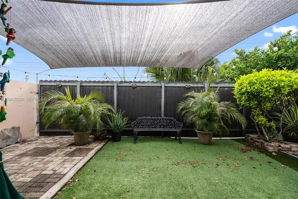 a view of a backyard with plants and a patio