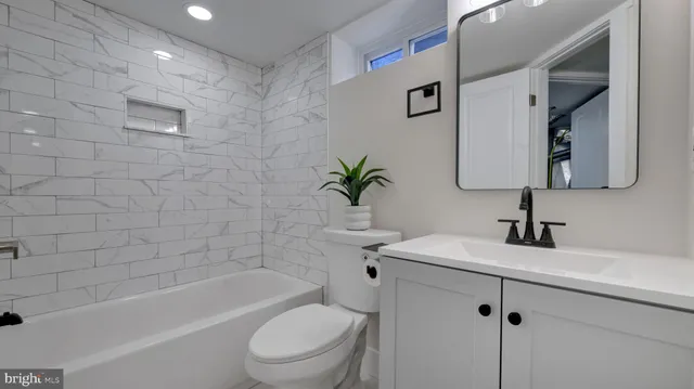 a bathroom with a sink a toilet and bathtub