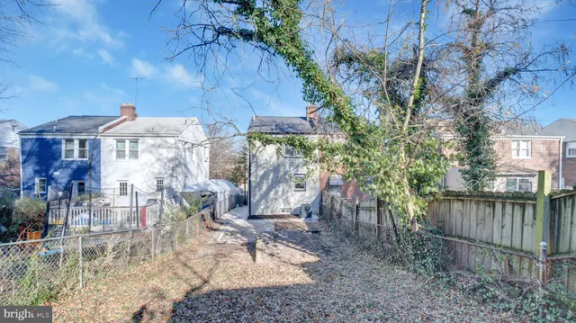 a view of a patio with a table and chairs under an umbrella