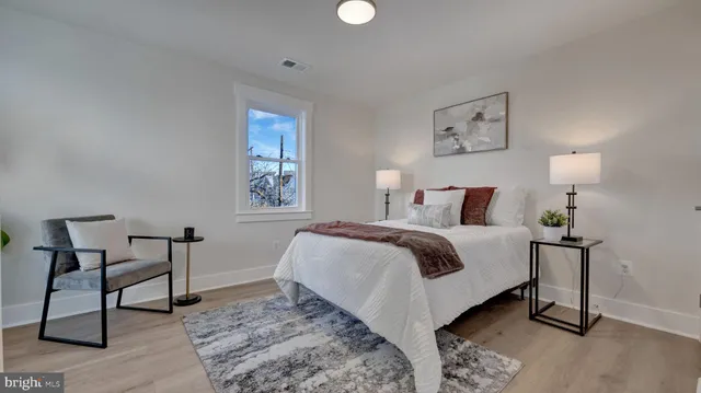 a bedroom with a bed and a lamp on table