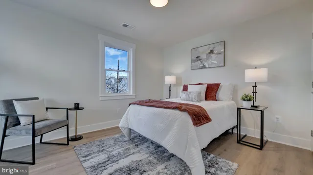 a bedroom with a bed and a lamp on table