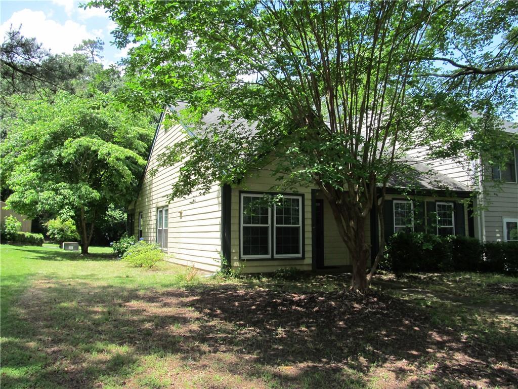1260 Warsaw Road Roswell, GA 30076 - Photo 1 of 1 a front view of a house with a yard