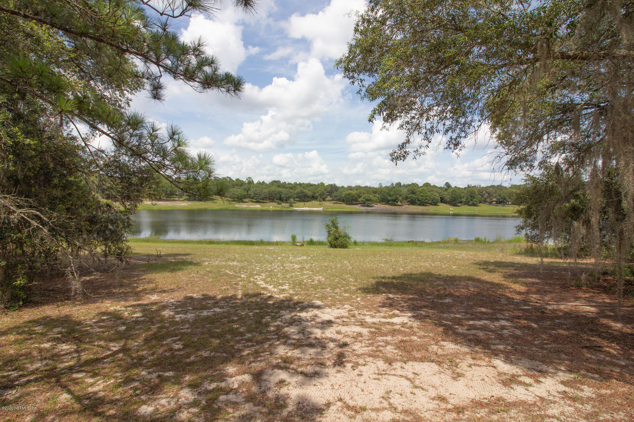 6988 Deer Springs Road Keystone Heights, FL 32656 - Photo 1 of 10 a view of a lake with houses in the back
