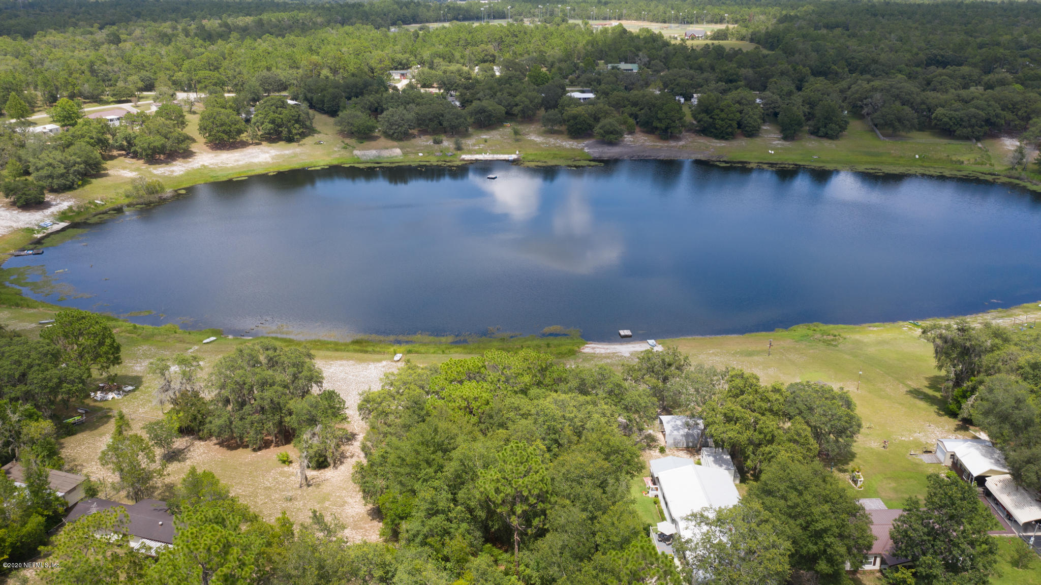 6988 Deer Springs Road Keystone Heights, FL 32656 - Photo 5 of 10 a view of a lake from a yard
