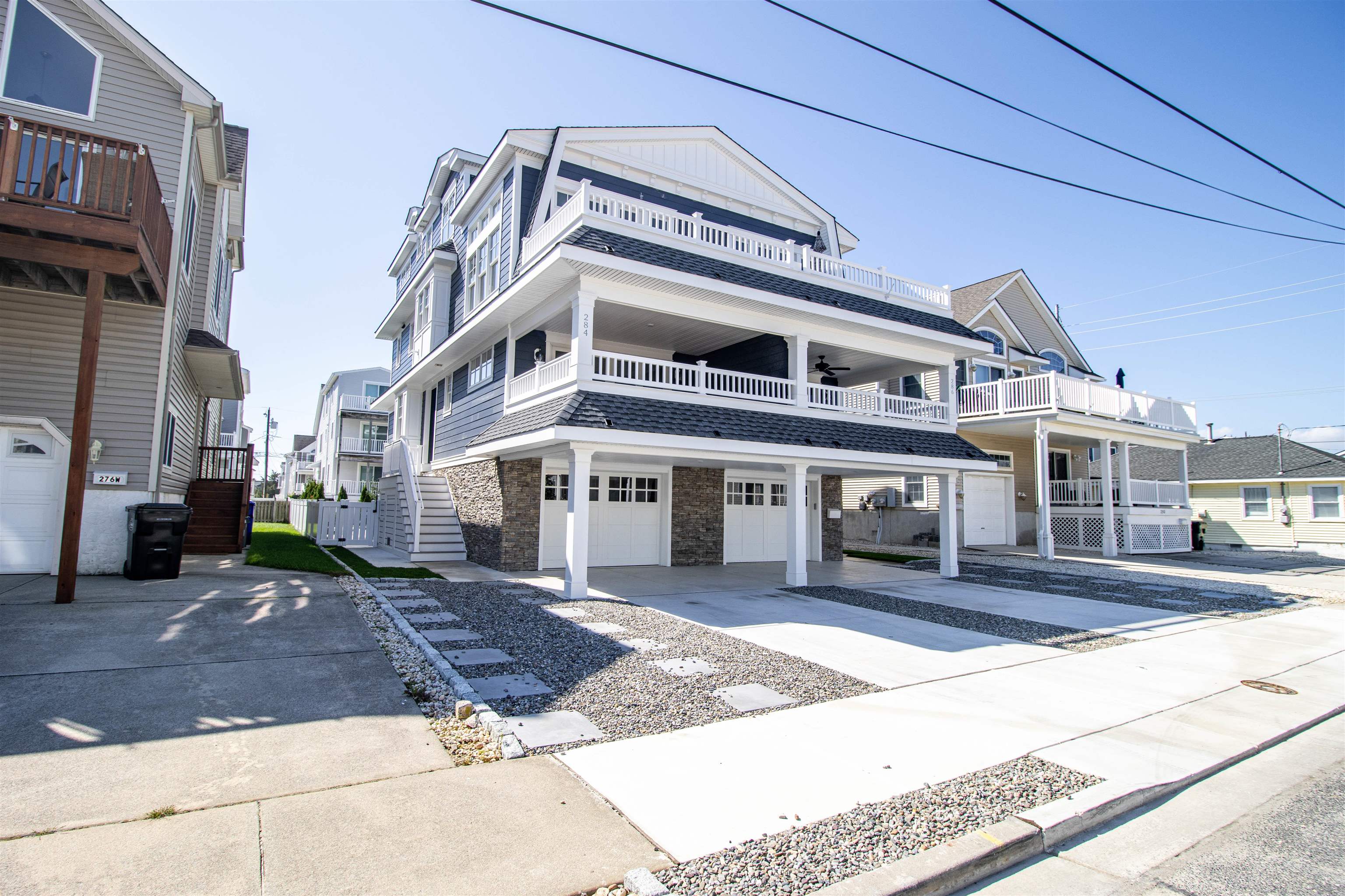 284 33rd, Unit 284 Avalon, NJ 08202 - Photo 1 of 28 a view of a building with many windows