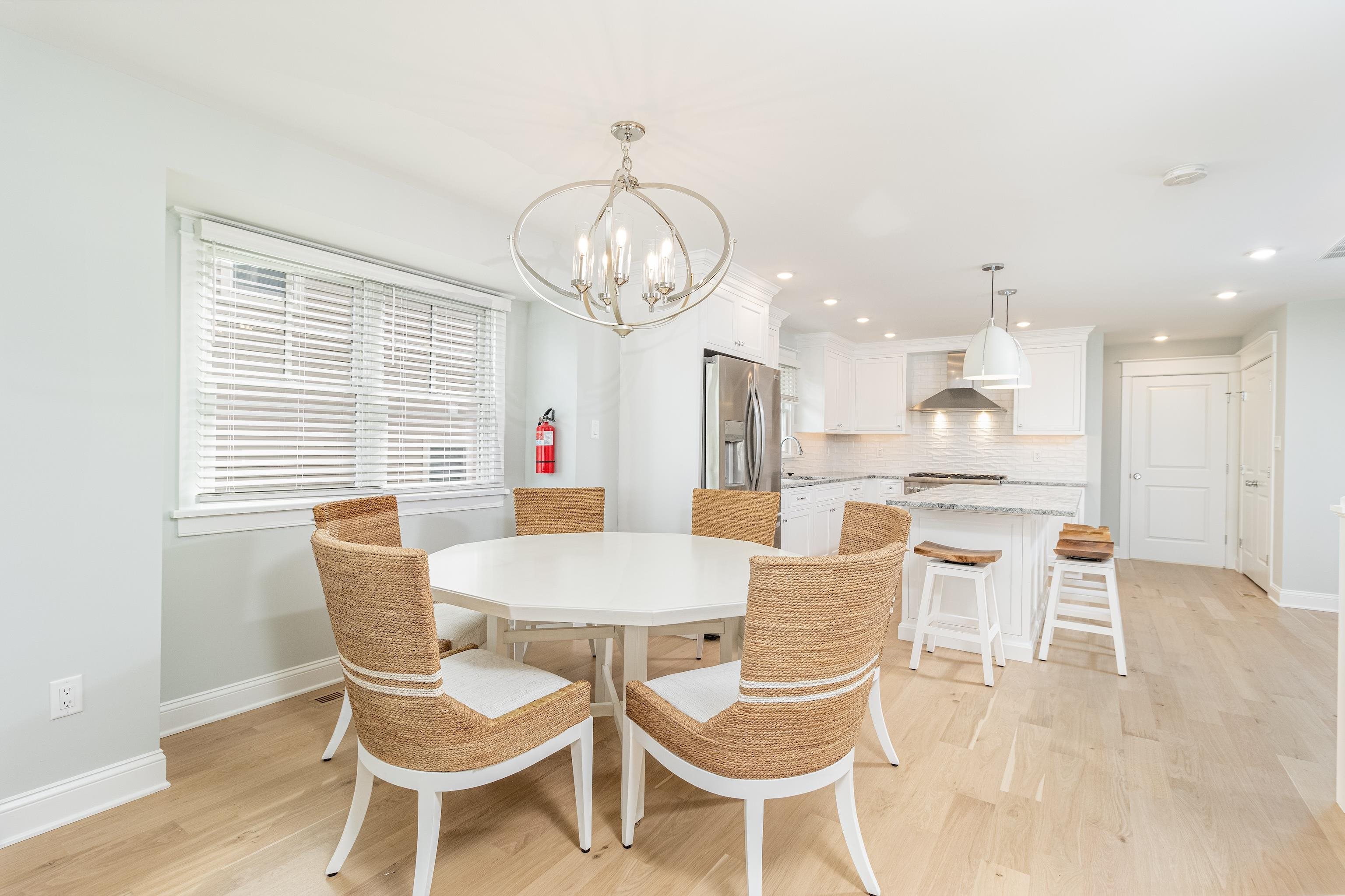 284 33rd, Unit 284 Avalon, NJ 08202 - Photo 12 of 28 a view of a dining room with furniture wooden floor and chandelier