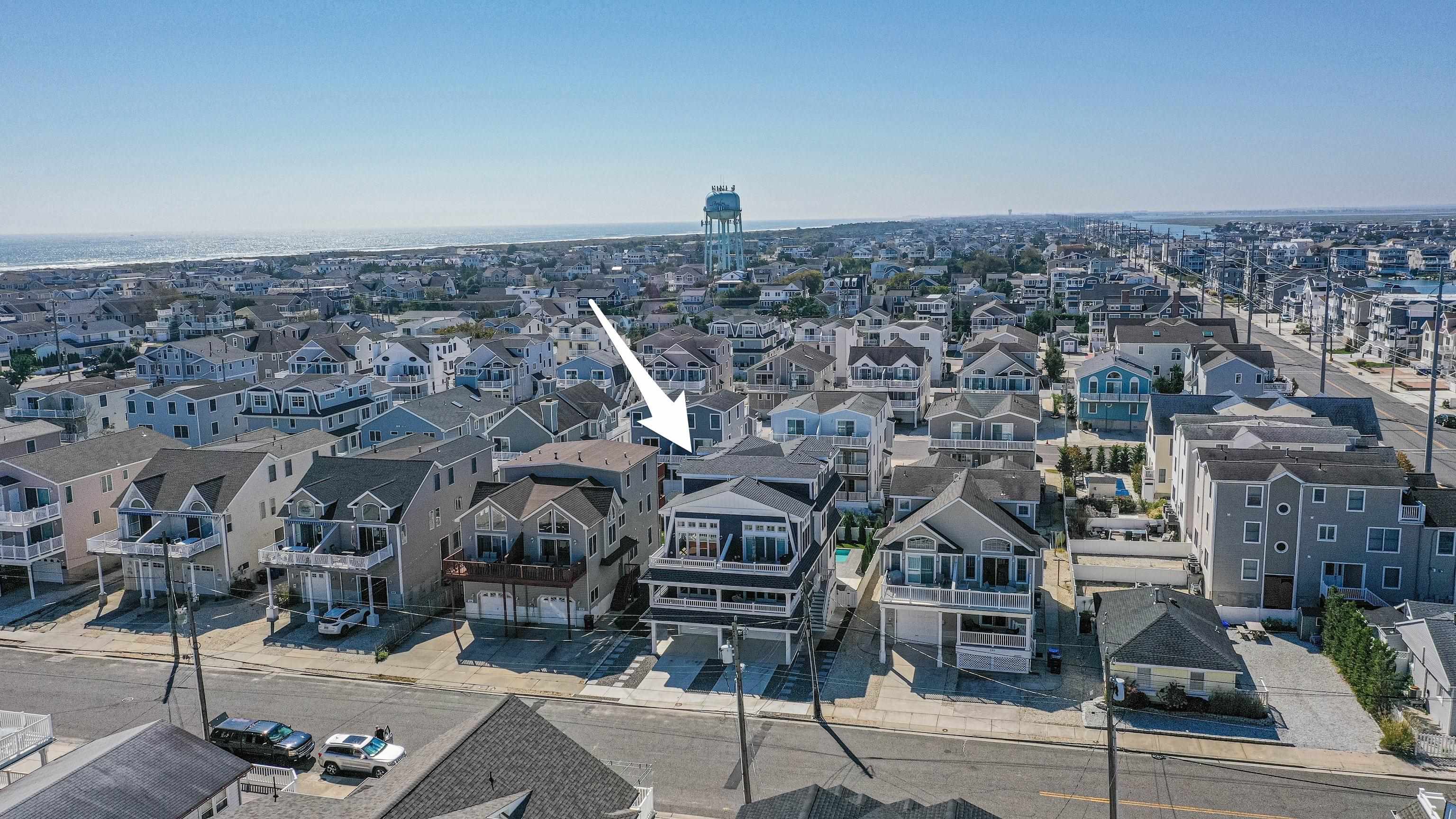 284 33rd, Unit 284 Avalon, NJ 08202 - Photo 3 of 28 an aerial view of a building with streets and trees
