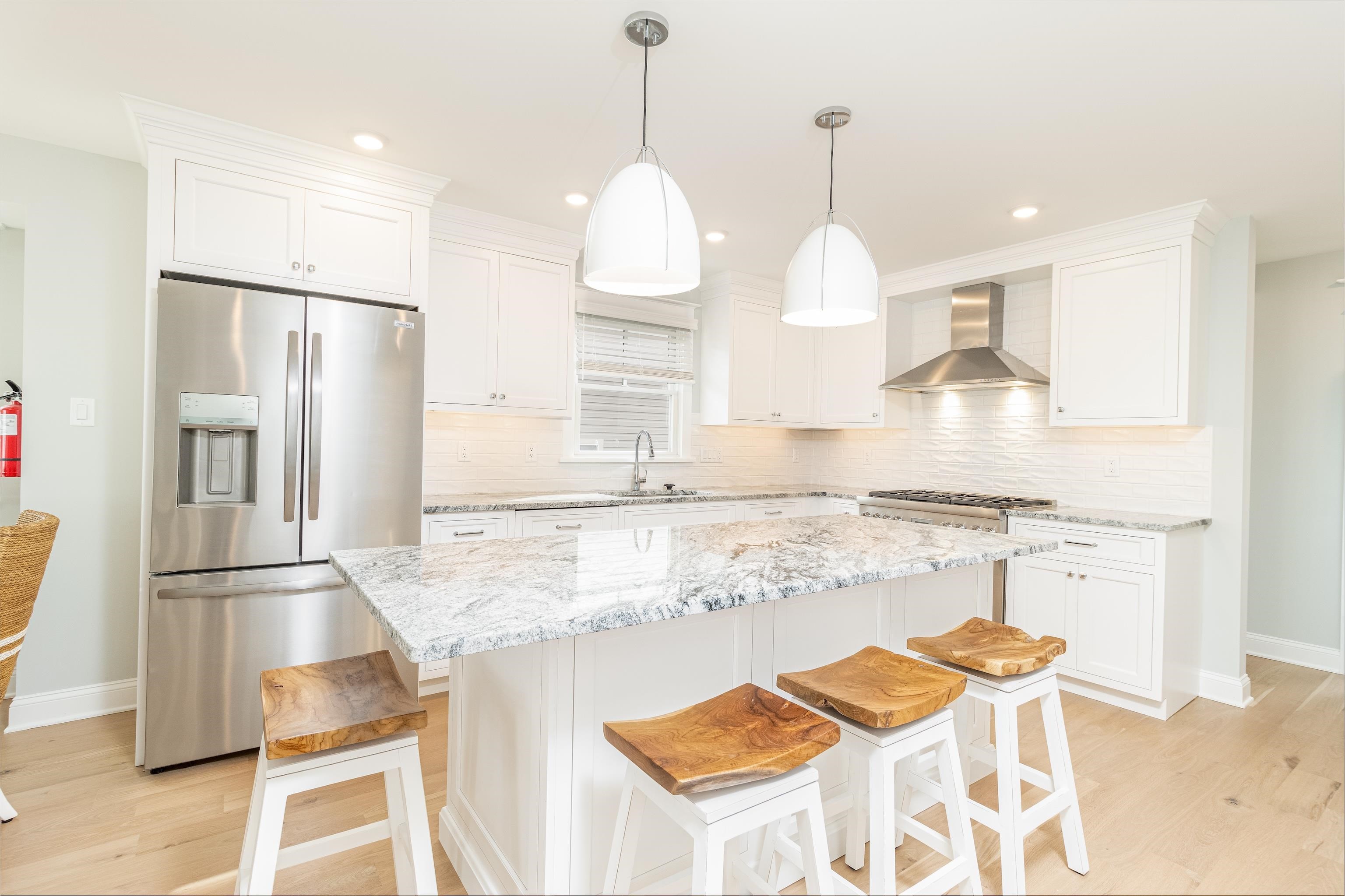 284 33rd, Unit 284 Avalon, NJ 08202 - Photo 10 of 28 a kitchen with stainless steel appliances granite countertop sink and refrigerator