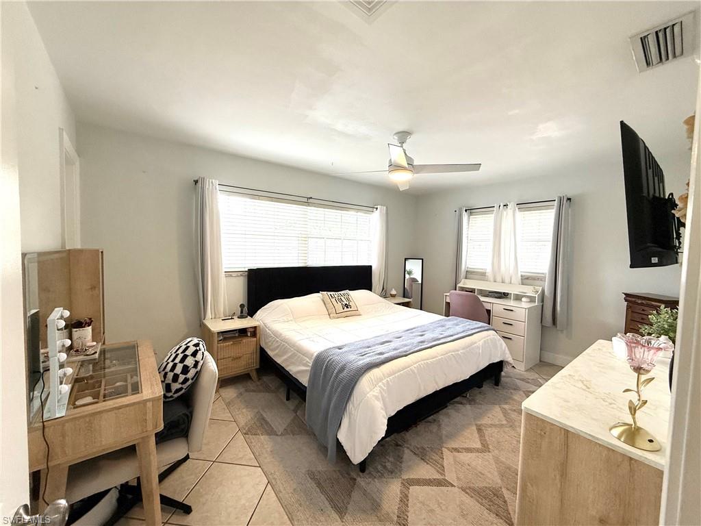 1964 42nd Street Southwest Naples, FL 34116 - Photo 12 of 25 a bedroom with a bed and wooden floor