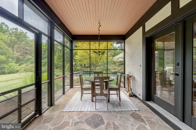 a living room with furniture and floor to ceiling windows