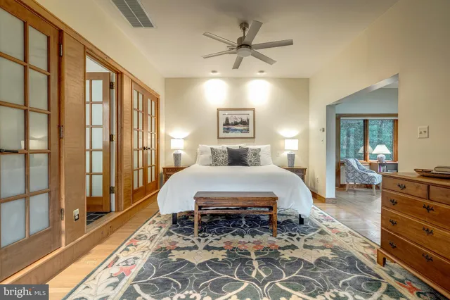 a bedroom with furniture and a potted plant