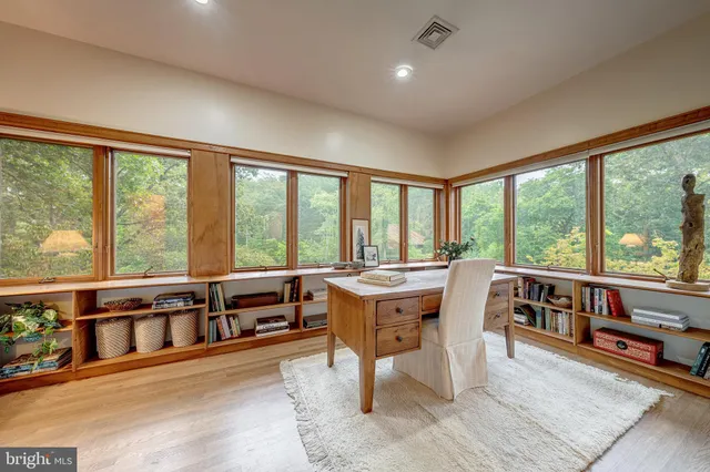 a living room with furniture and large windows