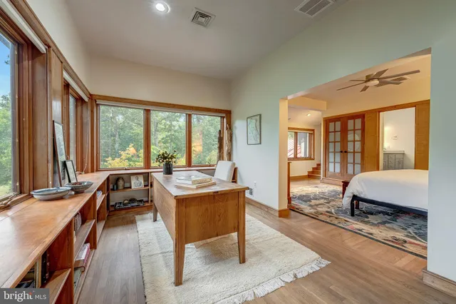 a living room with furniture and floor to ceiling windows