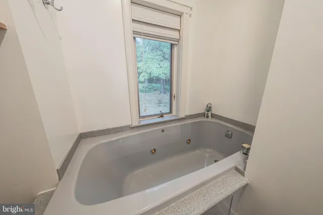 a room with wooden floor and a window