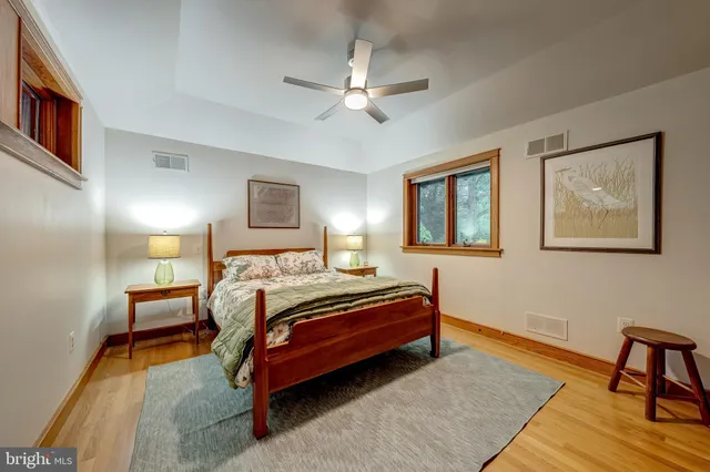 a bedroom with a large bed and a window