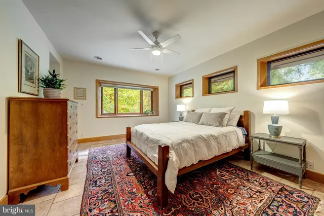 a bathroom with a granite countertop sink a mirror and a bathtub