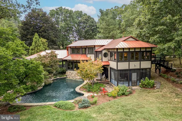 a swimming pool with outdoor seating and garden
