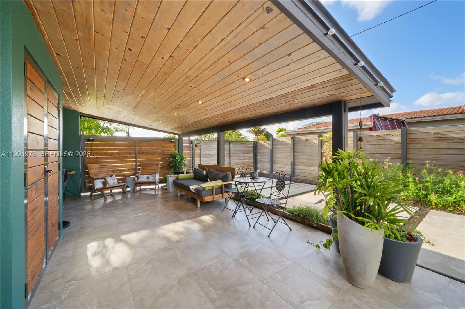 4315 Southwest 97th Court Miami, FL 33165 - Photo 13 of 17 a view of a patio with chairs and potted plants