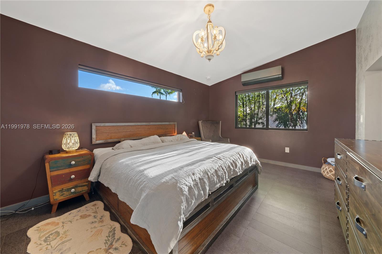 4315 Southwest 97th Court Miami, FL 33165 - Photo 8 of 17 a bedroom with a bed and a chandelier