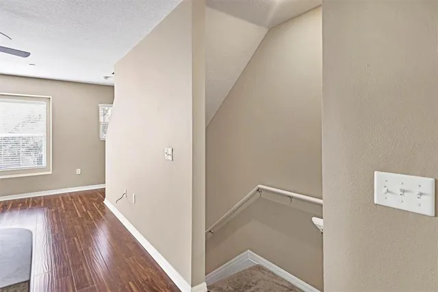 a view of room with window and wooden floor