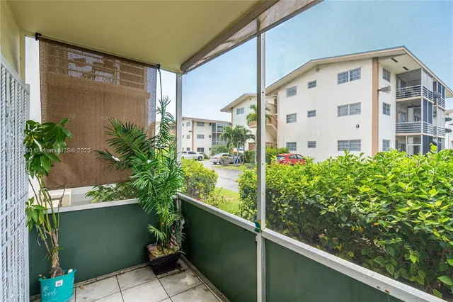 a front view of a house with plants