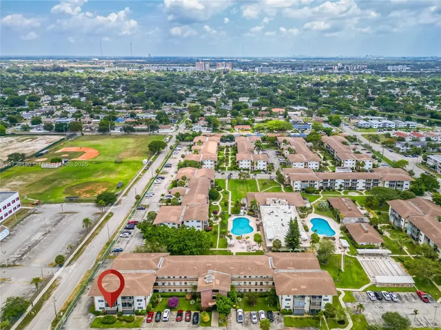 an aerial view of residential houses with outdoor space