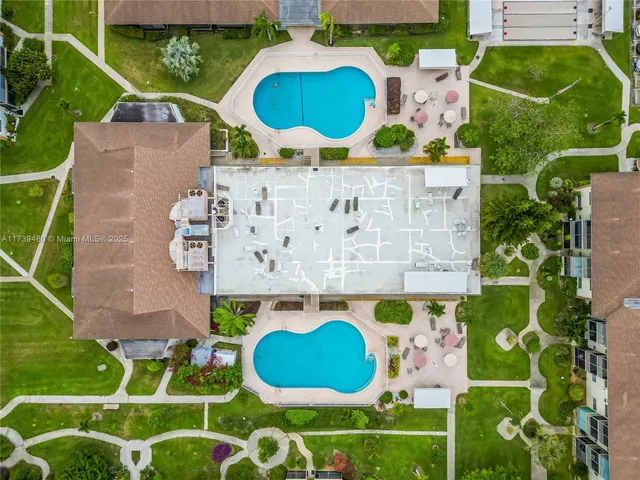 an aerial view of a house a yard and a swimming pool
