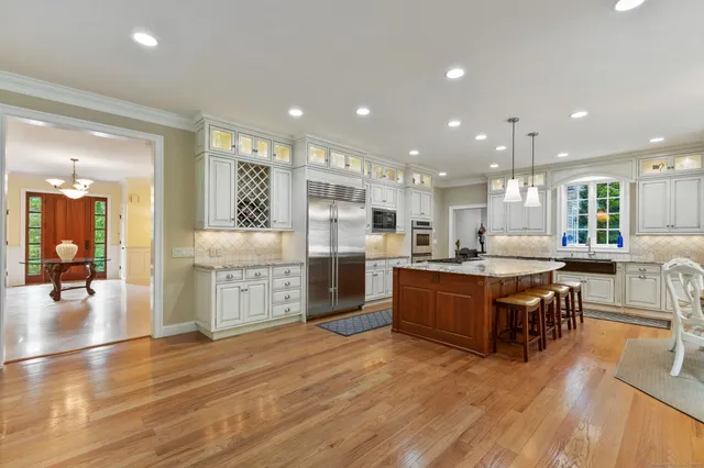 a large kitchen with stainless steel appliances lots of counter top space