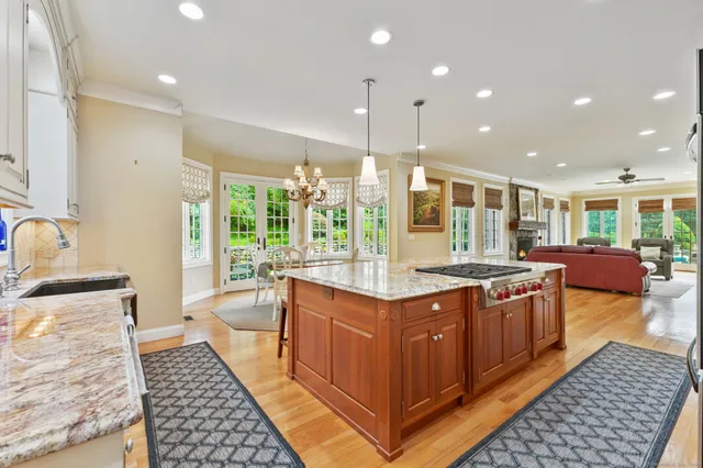 a kitchen with stainless steel appliances granite countertop a stove a sink and a refrigerator