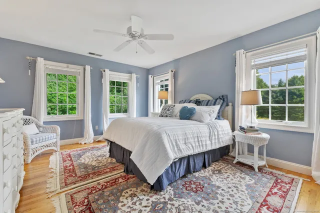 a bedroom with a large bed and a window