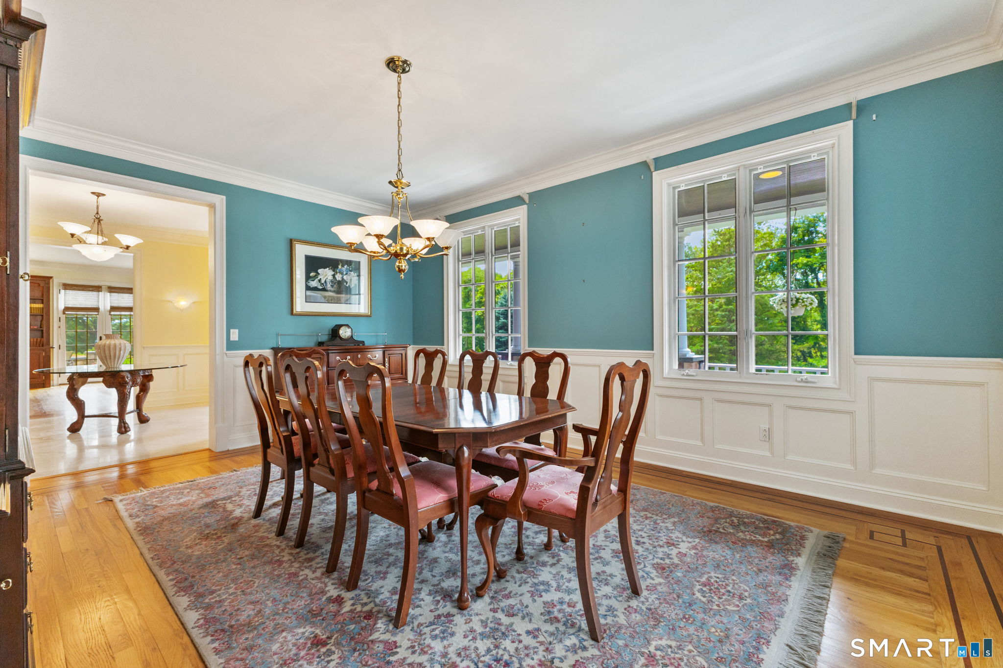 2 Longwood Drive Redding, CT 06896 - Photo 34 of 57 a dining room with furniture a chandelier and wooden floor