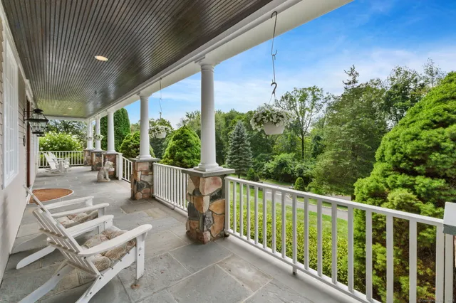 a view of a chairs and tables in the balcony