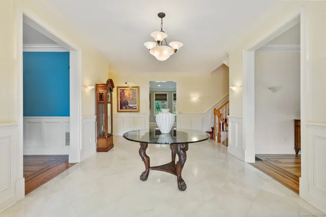 a view of a livingroom with a table and a chandelier