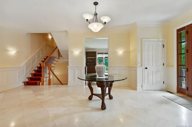 a view of a livingroom with furniture and stairs