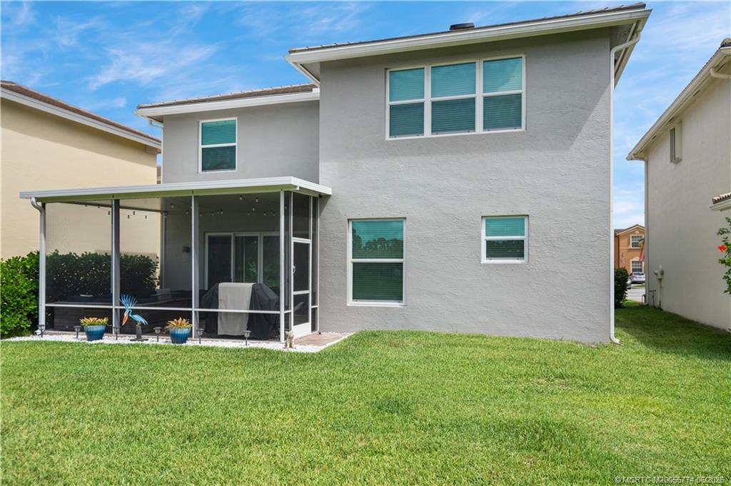 1268 Southeast Kirk Street Stuart, FL 34997 - Photo 50 of 63 a view of house with yard in front of it