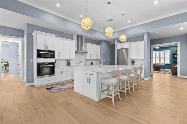 a spacious bedroom with a large bed and a chandelier