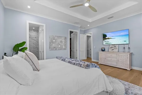 a dining room with furniture potted plants and wooden floor