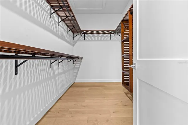 a large white kitchen with stainless steel appliances