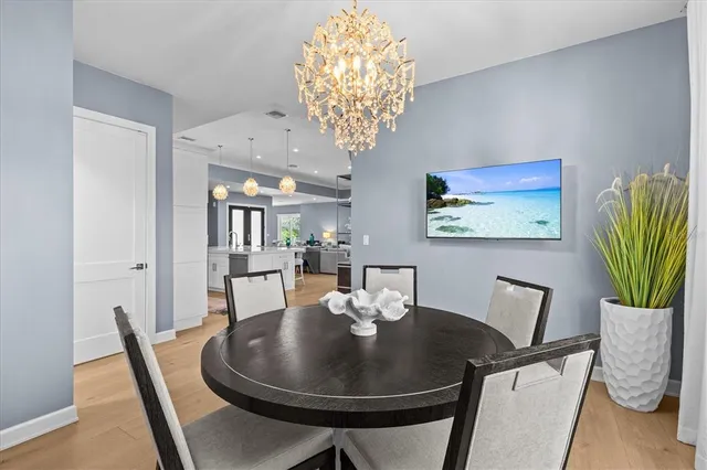 a view of a hallway with bathroom and wooden floor