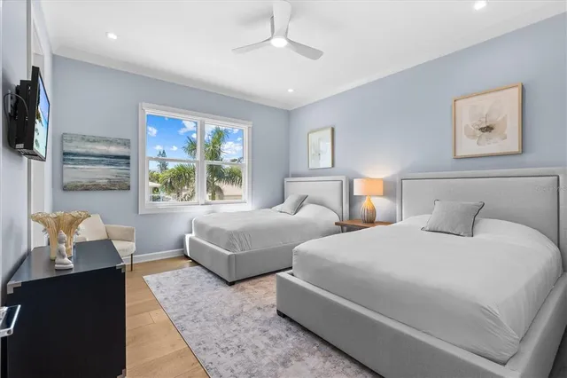 a bedroom with two beds and a window