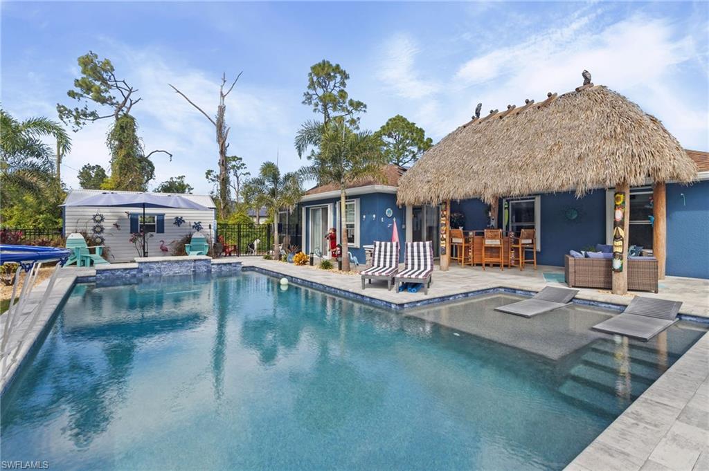 a view of a patio with swimming pool table and chairs
