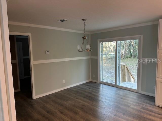 374 Sisco Road Pomona Park, FL 32181 - Photo 29 of 51 an empty room with wooden floor cabinet and windows