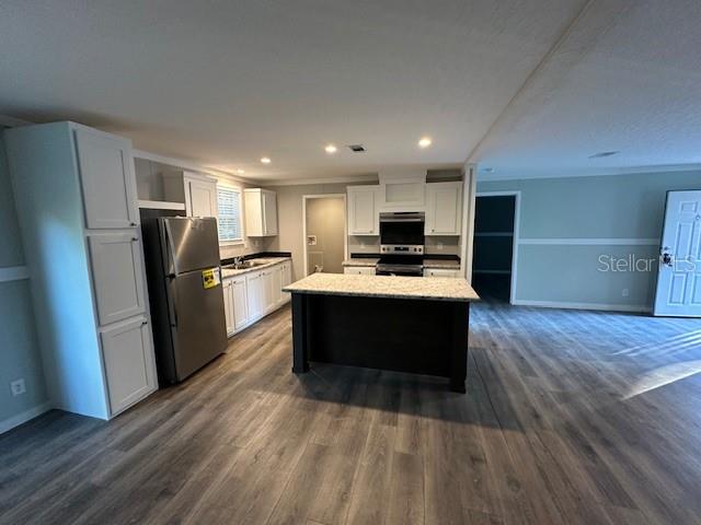 374 Sisco Road Pomona Park, FL 32181 - Photo 41 of 51 a kitchen with a refrigerator a sink and cabinets